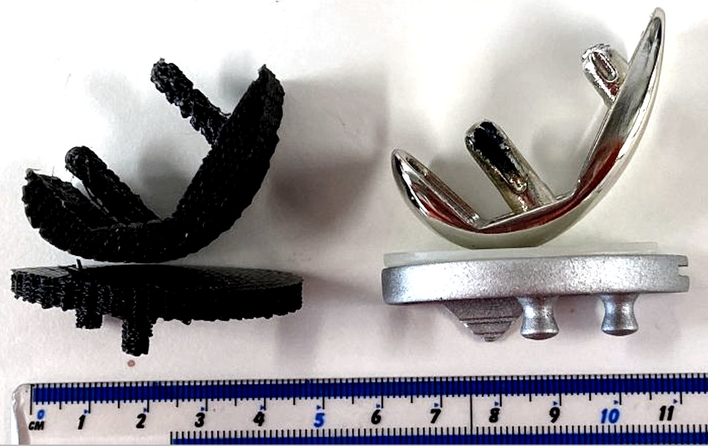 An early-stage 3D-printed, graphene-enhanced BioReJen® scaffold beside the conventional metal joint prosthesis it is designed to replace, shown to scale.